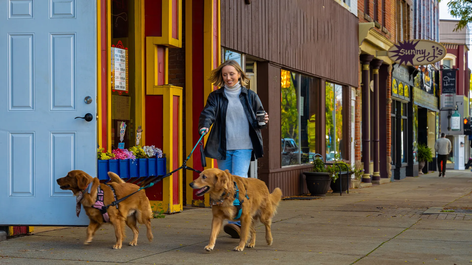 Woman walking dogs in howell with coffee