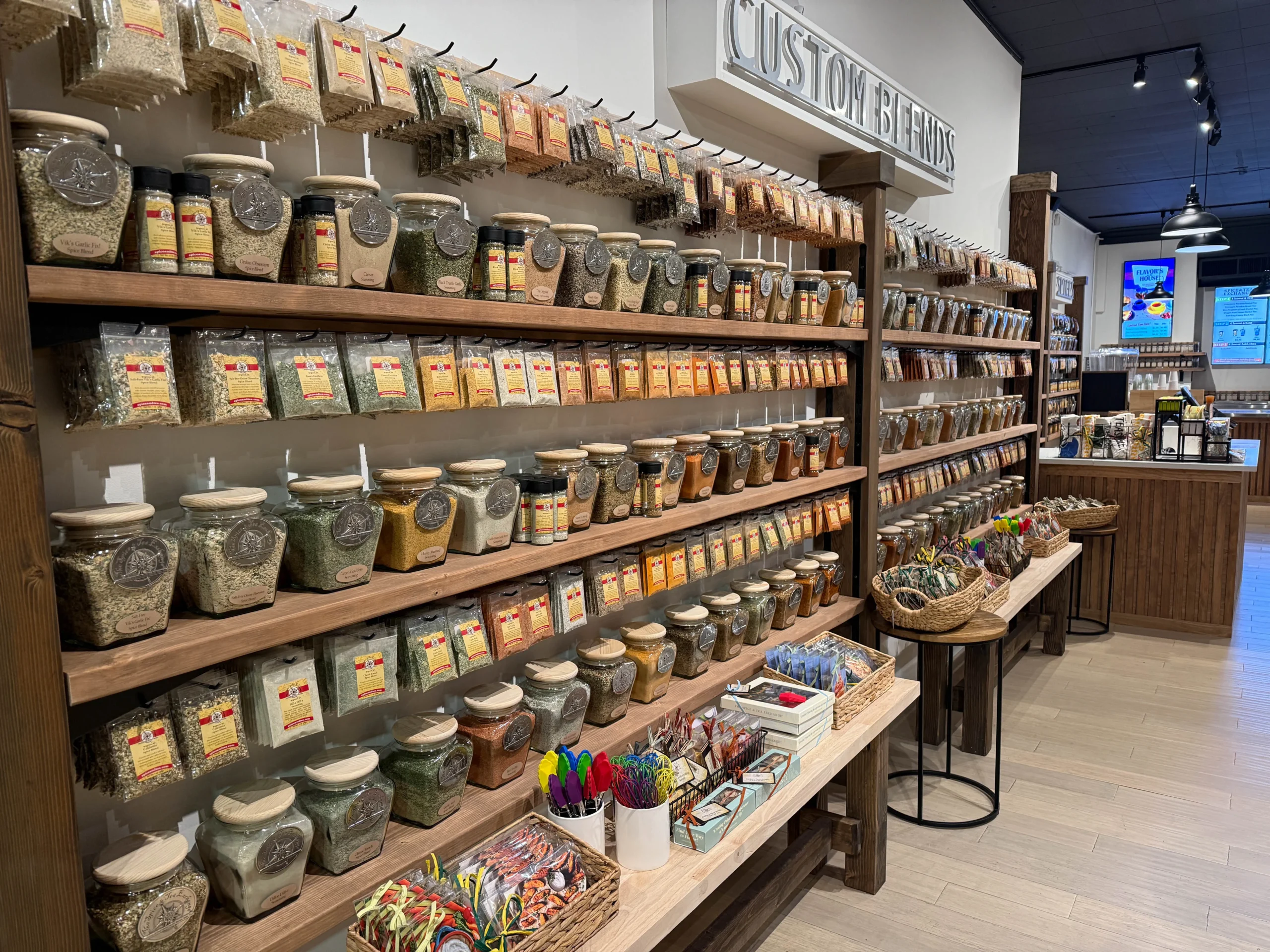 The Spice & Tea Exchange of Brighton wall of spices and mixes inside the store.